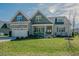 Charming two-story home with well-manicured lawn and attached two-car garage at 65 Walking Trl, Youngsville, NC 27596