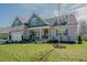 Traditional two-story home with attached two-car garage and nicely landscaped front yard at 65 Walking Trl, Youngsville, NC 27596