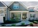 Nice exterior view of home featuring a covered porch with rocking chairs and manicured shrubs at 65 Walking Trl, Youngsville, NC 27596