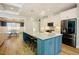 Modern kitchen featuring a granite island with seating, stainless steel appliances, and ample cabinet space at 65 Walking Trl, Youngsville, NC 27596