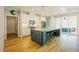 Bright, open kitchen with a large island, stainless steel appliances, and hardwood floors at 65 Walking Trl, Youngsville, NC 27596