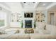 Bright living room boasts custom built-ins surrounding the fireplace and a comfortable sectional sofa at 65 Walking Trl, Youngsville, NC 27596