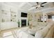 Cozy living room features a fireplace, built-in shelving, and a comfortable sectional sofa at 65 Walking Trl, Youngsville, NC 27596