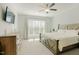 Comfortable main bedroom with a large window, soft carpet, and a rustic wood bed frame at 65 Walking Trl, Youngsville, NC 27596