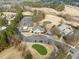 Aerial view of the community center, golf course, and surrounding neighborhood at 7 Windsor Glen Dr, Durham, NC 27703