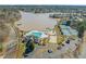 Aerial view of the community amenities, including a pool, tennis courts, and lake access at 7 Windsor Glen Dr, Durham, NC 27703