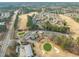 Aerial view of golf course and clubhouse in residential community at 7 Windsor Glen Dr, Durham, NC 27703