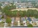 Aerial view of home in golf community with lush landscaping and mature trees at 7 Windsor Glen Dr, Durham, NC 27703