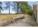 Backyard with a small patio and some trees at 7 Windsor Glen Dr, Durham, NC 27703
