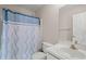 Modest bathroom featuring white fixtures and a blue and white shower curtain at 7 Windsor Glen Dr, Durham, NC 27703