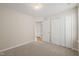 Neutral bedroom featuring plush carpeting and a double door closet at 7 Windsor Glen Dr, Durham, NC 27703