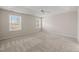 Bright, neutral bedroom with a ceiling fan, carpeted floors and two bright windows at 7 Windsor Glen Dr, Durham, NC 27703
