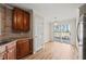 Cozy kitchen nook with wood cabinets, light countertops, access to the backyard, and wood flooring at 7 Windsor Glen Dr, Durham, NC 27703