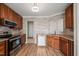 Well-lit kitchen features stainless steel appliances, light wood flooring, and stone-style accent wall at 7 Windsor Glen Dr, Durham, NC 27703