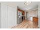 Updated kitchen featuring stainless steel appliances, light-tone wood floors, and white stone accent wall at 7 Windsor Glen Dr, Durham, NC 27703