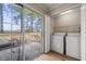 Bright laundry room with sliding glass doors to the backyard and side-by-side washer and dryer at 7 Windsor Glen Dr, Durham, NC 27703