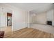 Open living space featuring hardwood floors, an archway, and a fireplace at 7 Windsor Glen Dr, Durham, NC 27703