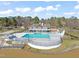 Aerial view of the community pool and clubhouse with lake view at 7 Windsor Glen Dr, Durham, NC 27703