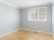 Cozy bedroom with light blue walls, hardwood floors, and white trim, creating a calming atmosphere at 709 Fitzgerald Dr, Raleigh, NC 27610
