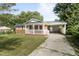 Attractive brick home featuring a covered porch and side carport, set in a leafy landscape at 709 Fitzgerald Dr, Raleigh, NC 27610