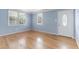 Inviting living room with pristine hardwood floors, two windows, and freshly painted walls at 709 Fitzgerald Dr, Raleigh, NC 27610