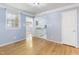 Cozy room with hardwood floors and fresh blue paint with pass-through to kitchen at 709 Fitzgerald Dr, Raleigh, NC 27610
