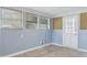 Light-filled sunroom featuring vinyl floors, light blue walls, and numerous windows for natural light at 709 Fitzgerald Dr, Raleigh, NC 27610