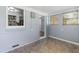 Bright sunroom with vinyl tile flooring, painted brick, and multiple windows creating a cheerful space at 709 Fitzgerald Dr, Raleigh, NC 27610
