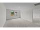 Spacious bedroom featuring neutral carpet and walls, with ample natural light coming through two windows at 801 Berkeley Glen Rd, Zebulon, NC 27597