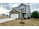 Charming two-story home with neutral-colored siding and a front-entry garage at 801 Berkeley Glen Rd, Zebulon, NC 27597