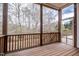 Screened-in back porch with wood flooring and railing at 804 Long Meadows Rd, Chapel Hill, NC 27516