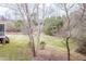 Spacious backyard with walking path, grass and bare trees at 804 Long Meadows Rd, Chapel Hill, NC 27516