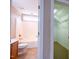 Bathroom with shower-tub combo, light wood vanity, with closet through doorway at 804 Long Meadows Rd, Chapel Hill, NC 27516