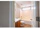 Clean, well-lit bathroom with shower-tub combo, light wood vanity, and neutral tile floor at 804 Long Meadows Rd, Chapel Hill, NC 27516