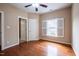 Bedroom with hardwood floors, a ceiling fan and a window with plantation shutters at 804 Long Meadows Rd, Chapel Hill, NC 27516