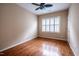 Bedroom with hardwood floors, a ceiling fan and a window with plantation shutters at 804 Long Meadows Rd, Chapel Hill, NC 27516