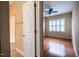 Bedroom and bath featuring hardwood floors, ceiling fan and neutral paint at 804 Long Meadows Rd, Chapel Hill, NC 27516