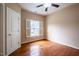 Bright bedroom features hardwood floors, a ceiling fan and a window with plantation shutters at 804 Long Meadows Rd, Chapel Hill, NC 27516