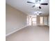 Large carpeted bedroom with bright natural light, multiple doors, and ceiling fans at 804 Long Meadows Rd, Chapel Hill, NC 27516