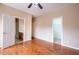 Bedroom featuring hardwood floors, neutral paint, and multiple doorways at 804 Long Meadows Rd, Chapel Hill, NC 27516