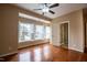 Large bedroom with hardwood floors, ceiling fan and windows with plantation shutters at 804 Long Meadows Rd, Chapel Hill, NC 27516