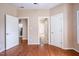 Spacious bedroom with hardwood floors, neutral paint and three doorways at 804 Long Meadows Rd, Chapel Hill, NC 27516