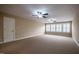 Spacious bedroom with plush carpet, neutral paint, two ceiling fans, and bright windows at 804 Long Meadows Rd, Chapel Hill, NC 27516