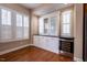 Dining area with white cabinets, wine storage, granite counters and natural light from large windows at 804 Long Meadows Rd, Chapel Hill, NC 27516