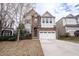 Beautiful two-story home with a stone facade and attached two-car garage at 804 Long Meadows Rd, Chapel Hill, NC 27516