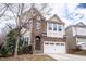 Attractive two-story home featuring a stone facade and an integrated two-car garage at 804 Long Meadows Rd, Chapel Hill, NC 27516