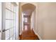 Hallway with hardwood floors, a white door with glass panels and an arched ceiling at 804 Long Meadows Rd, Chapel Hill, NC 27516