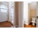 Entryway with hardwood floors, a white arched doorway, glass paneled door, and powder room at 804 Long Meadows Rd, Chapel Hill, NC 27516