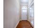 Entryway with hardwood floors, a white arched doorway, glass paneled door, and neutral wall color at 804 Long Meadows Rd, Chapel Hill, NC 27516