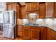 Gourmet kitchen featuring custom cabinets, granite countertops, stainless appliances, and gas cooktop at 804 Long Meadows Rd, Chapel Hill, NC 27516